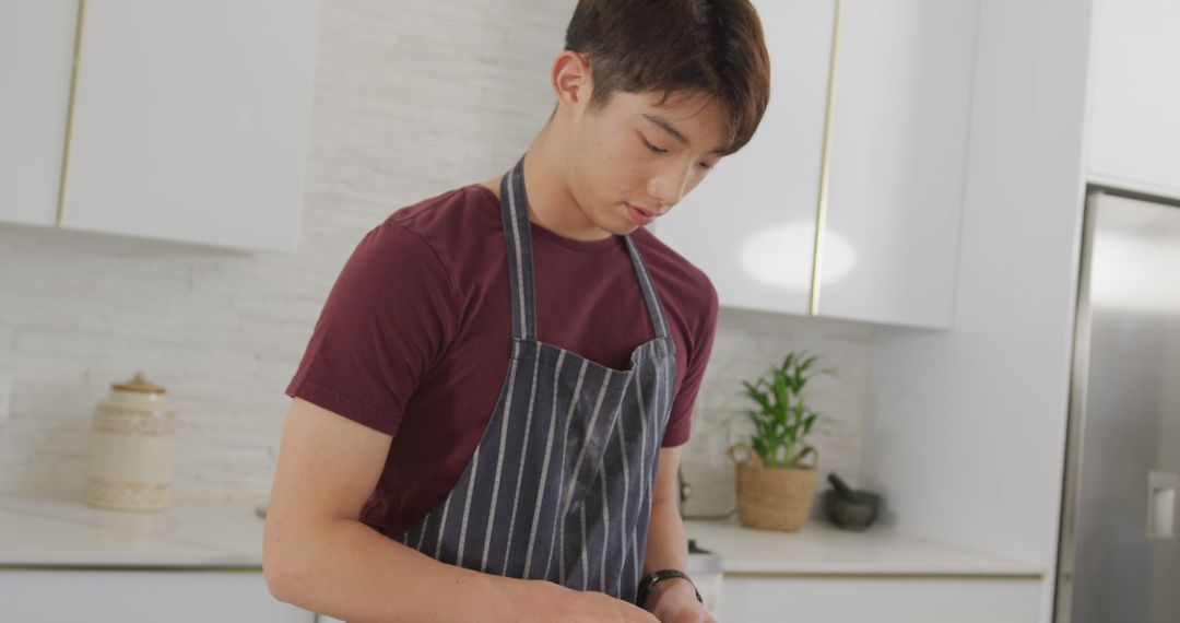 Young Man Cooking in Modern Kitchen with Concentration - Free Images, Stock Photos and Pictures on Pikwizard.com