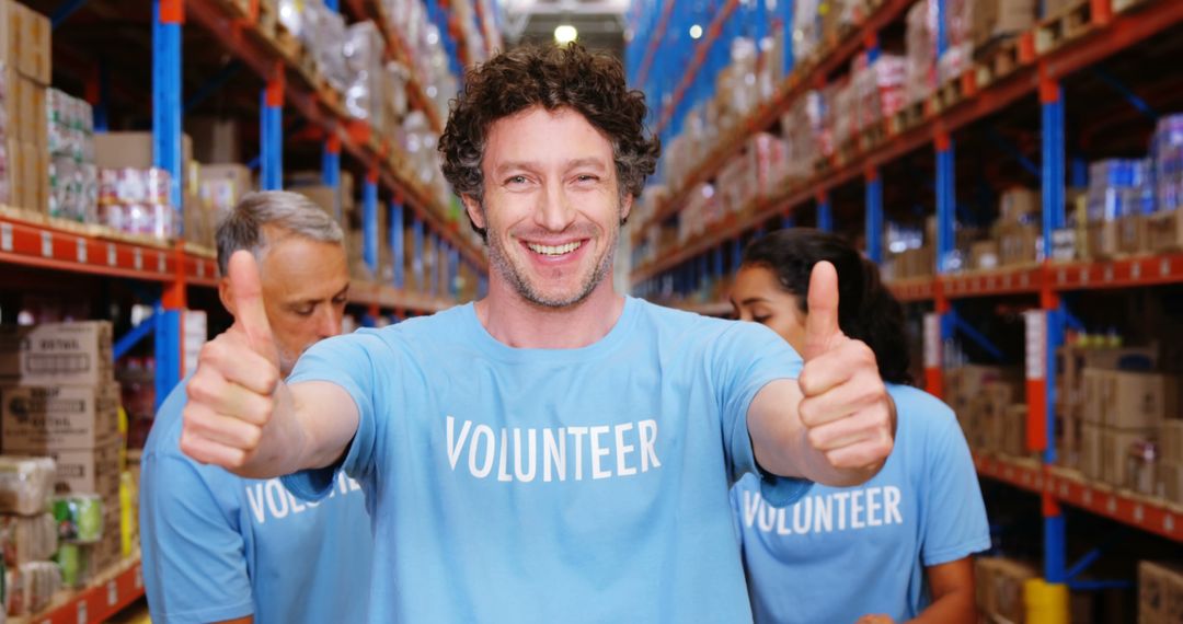 Smiling Volunteer Giving Thumbs Up in Donation Warehouse - Free Images, Stock Photos and Pictures on Pikwizard.com