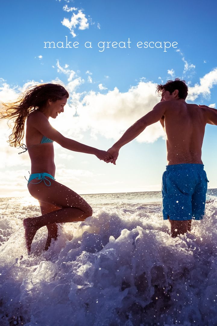 Joyful Couple Jumping over Ocean Waves for Romantic Getaway