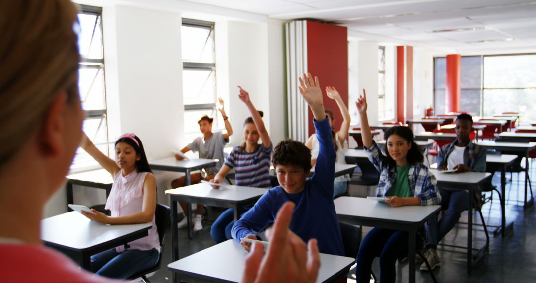 Engaged Students Raising Hands in a Modern Classroom - Free Images, Stock Photos and Pictures on Pikwizard.com