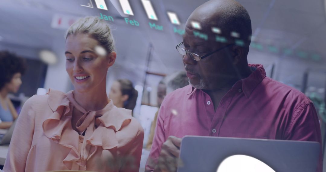 Diverse Team Analyzing Financial Data on Digital Interface in Modern Office