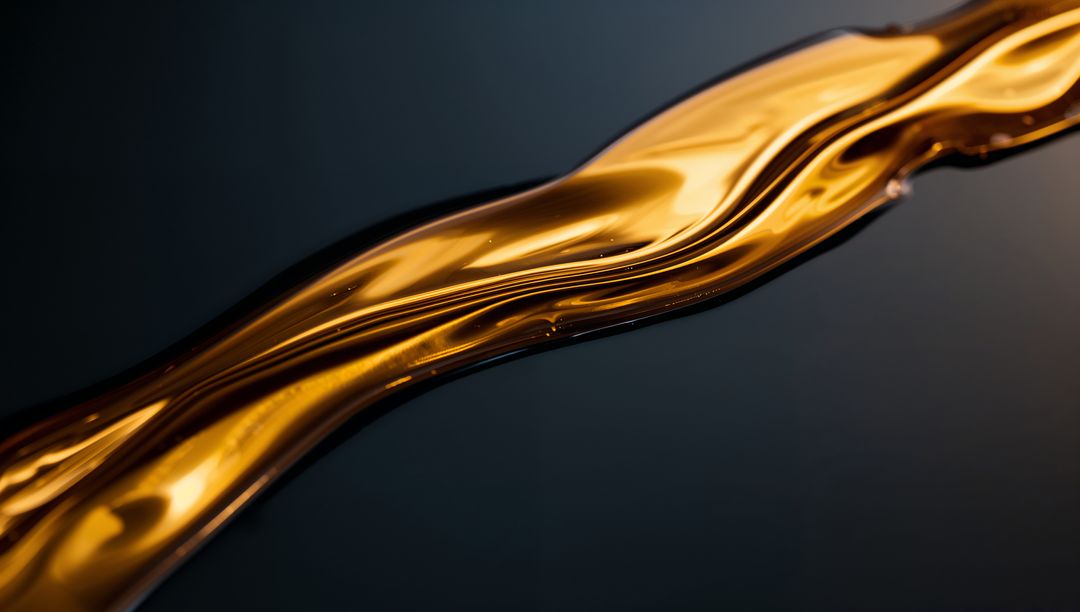 Glossy Golden Liquid Ribbon Flowing Over Dark Surface Macro Abstract Luxury Background