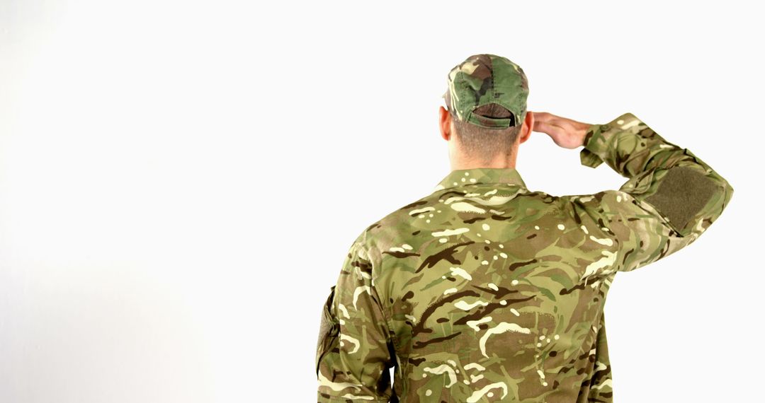 Caucasian Soldier in Camouflage Uniform Saluting Respectfully
