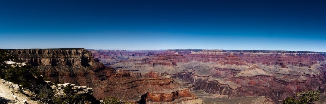 Panoramic View of the Grand Canyon under Clear Blue Sky - Free Images, Stock Photos and Pictures on Pikwizard.com