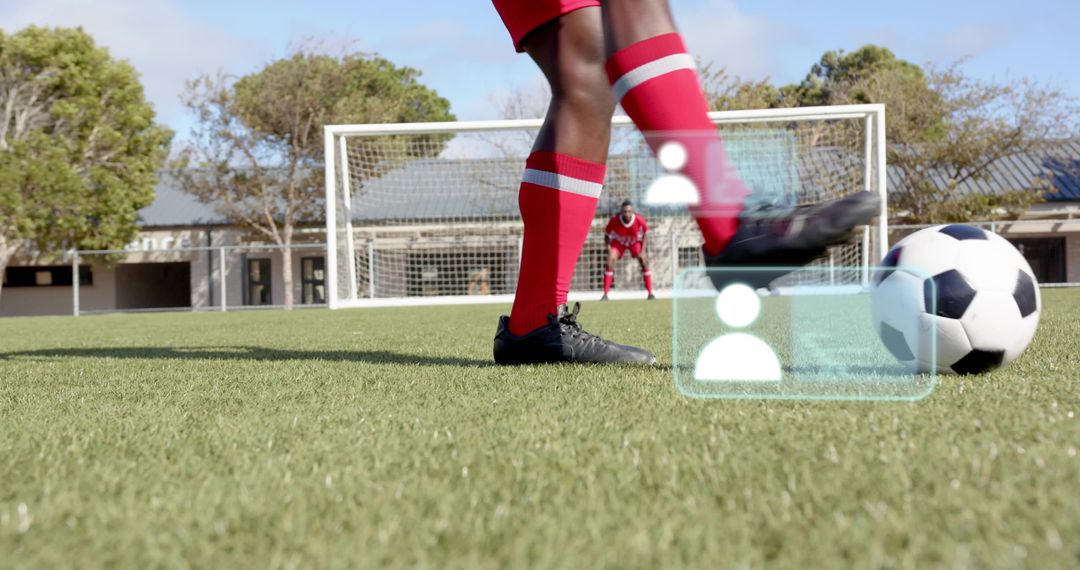 Kicking Soccer Player Striking Ball Toward Goal with AR Overlays on School Pitch