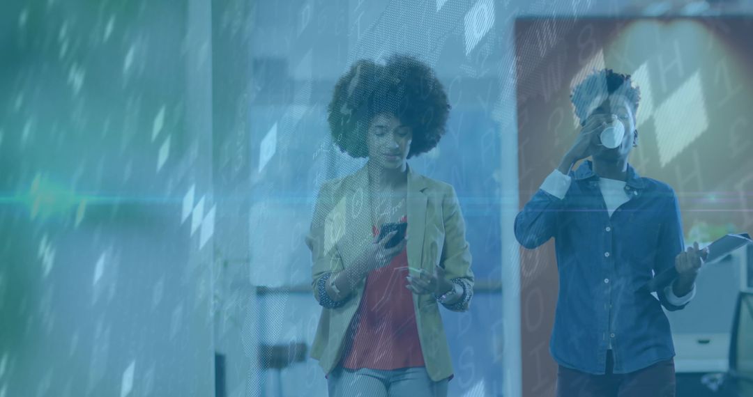 Coworkers Engaging with Technology While Walking in Office Hallway