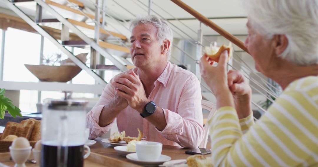 Senior Couple Enjoying Breakfast Conversation at Home