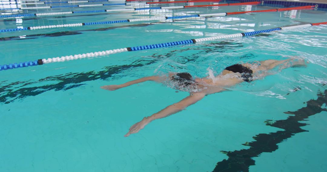 Athlete Performing Front Crawl in Competitive Pool Lane