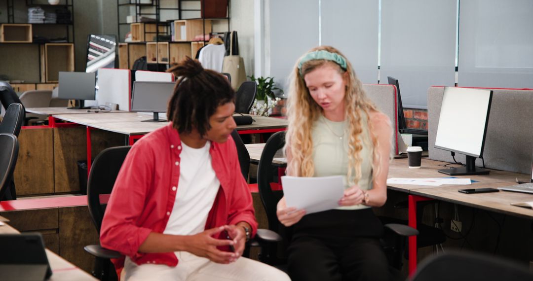 Colleagues Collaborating on Documents in Modern Office