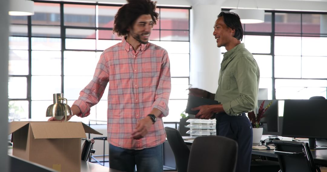 Colleagues Unpacking Office Box Cooperation