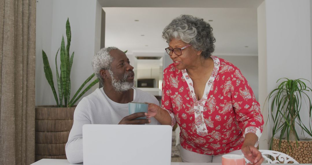 Senior Couple Utilizing Laptop in Cozy Home Environment