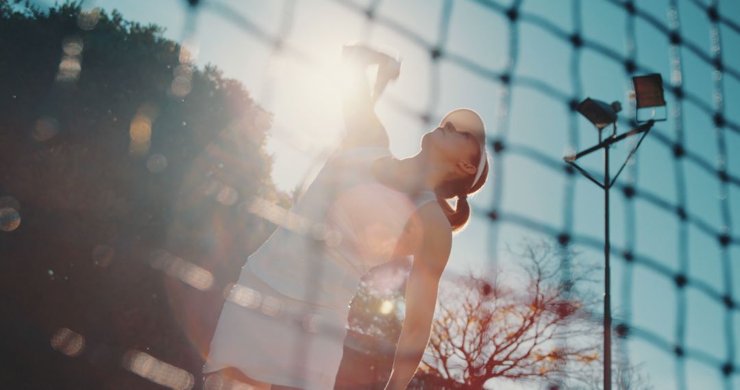 Tennis player serving ball on sunny day - Free Images, Stock Photos and Pictures on Pikwizard.com