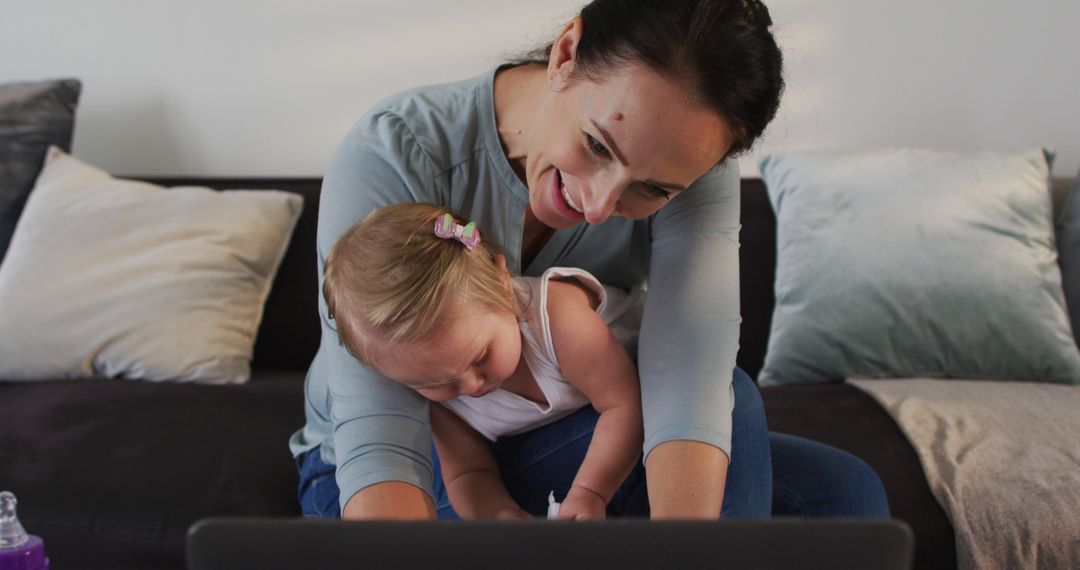 Happy Mother Multitasking with Her Baby at Home