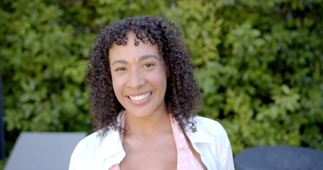 Woman Smiling Outdoors on Sunny Day in Backyard