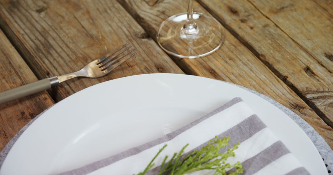 Rustic Table Setting with Striped Napkin and Wine Glass - Free Images, Stock Photos and Pictures on Pikwizard.com