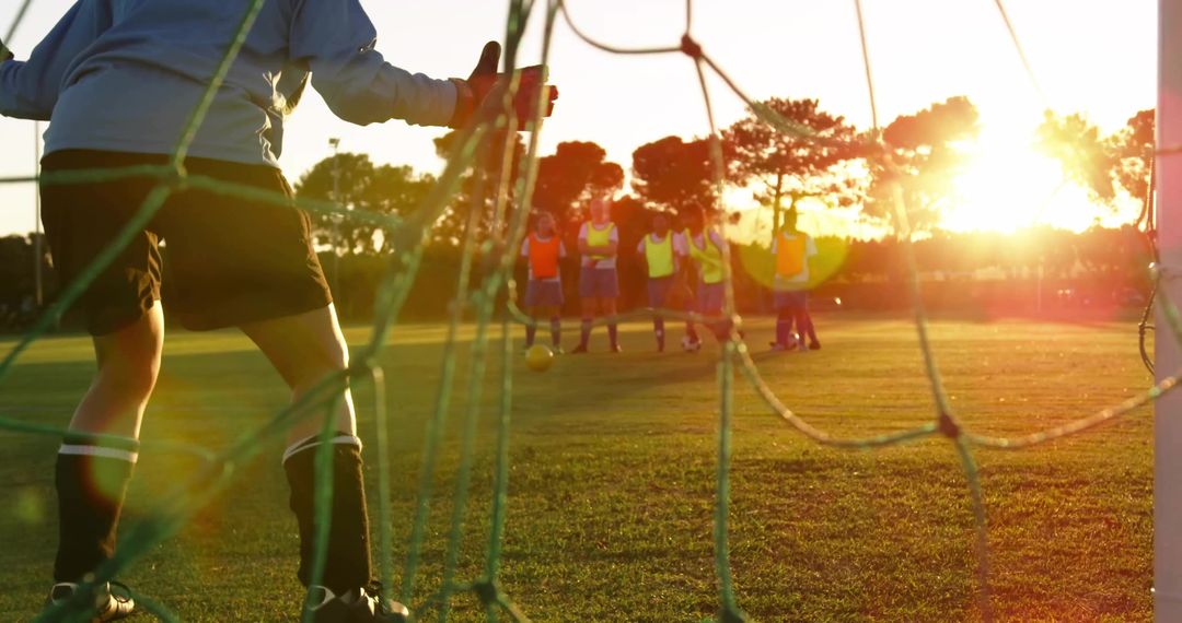 Goalkeeper Preparing for Kick in Late Sunlight on Field