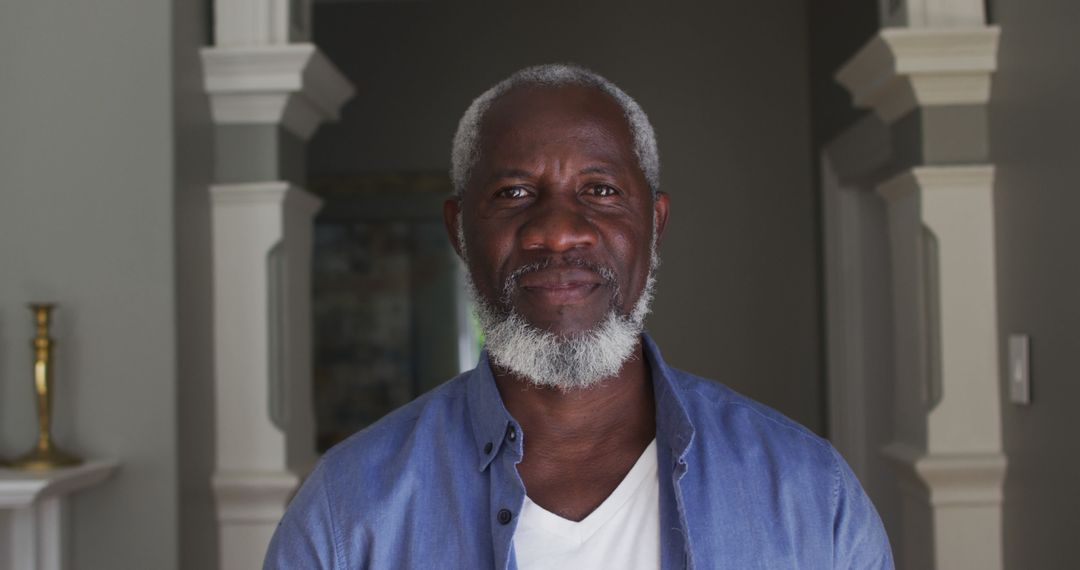 Confident Senior Man with Grey Beard and Blue Shirt at Home - Free Images, Stock Photos and Pictures on Pikwizard.com