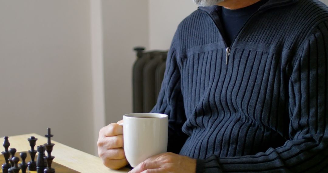 Man Drinking Coffee While Playing Chess - Free Images, Stock Photos and Pictures on Pikwizard.com