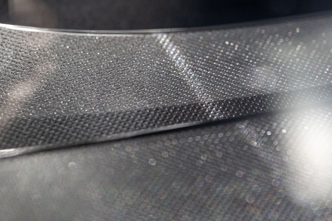 Textured Metallic Surface with Reflective Light Patterns