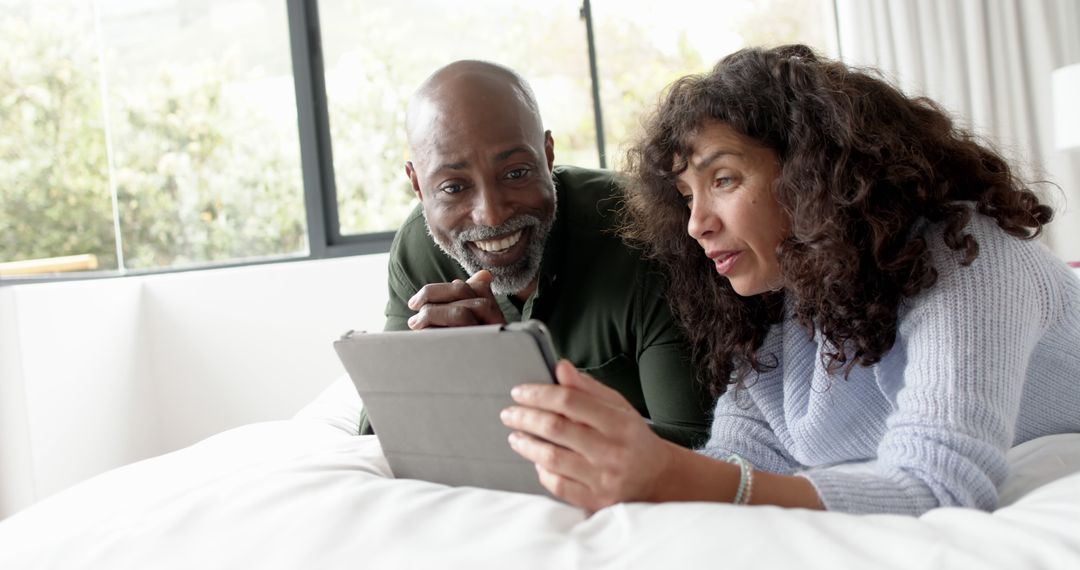 Couple Relaxing in Bed Using Digital Tablet Together - Free Images, Stock Photos and Pictures on Pikwizard.com