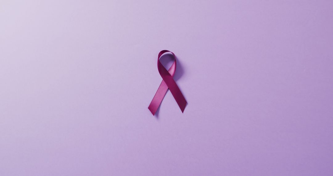 Image of close up of purple pancreatic cancer ribbon on blue background - Free Images, Stock Photos and Pictures on Pikwizard.com