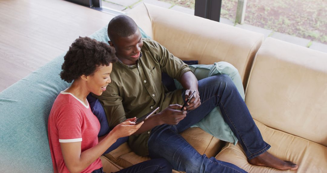 Happy Couple Relaxing on Couch Using Smartphones - Free Images, Stock Photos and Pictures on Pikwizard.com