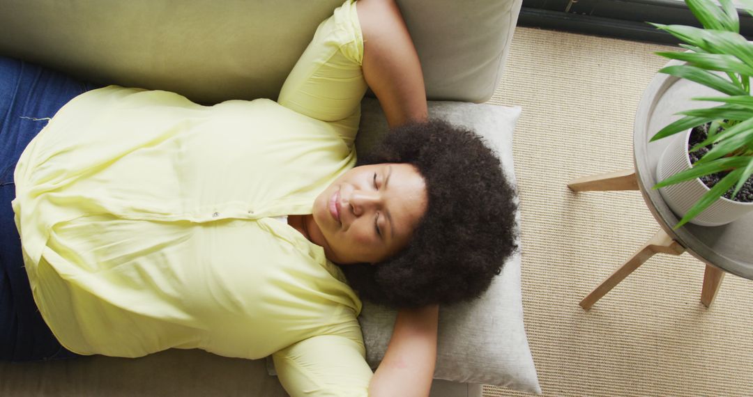 Relaxed African American Woman Lying on Sofa - Free Images, Stock Photos and Pictures on Pikwizard.com