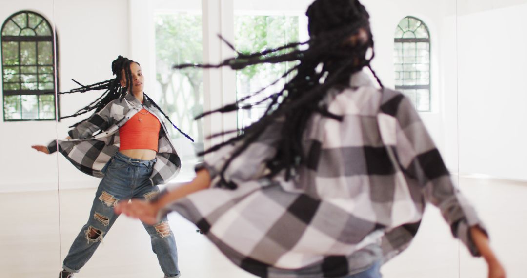 Professional african american female dancer exercising alone in dance studio - Free Images, Stock Photos and Pictures on Pikwizard.com