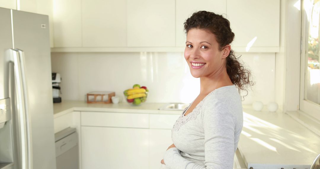 Smiling Woman in Bright Kitchen with Modern Appliances - Free Images, Stock Photos and Pictures on Pikwizard.com