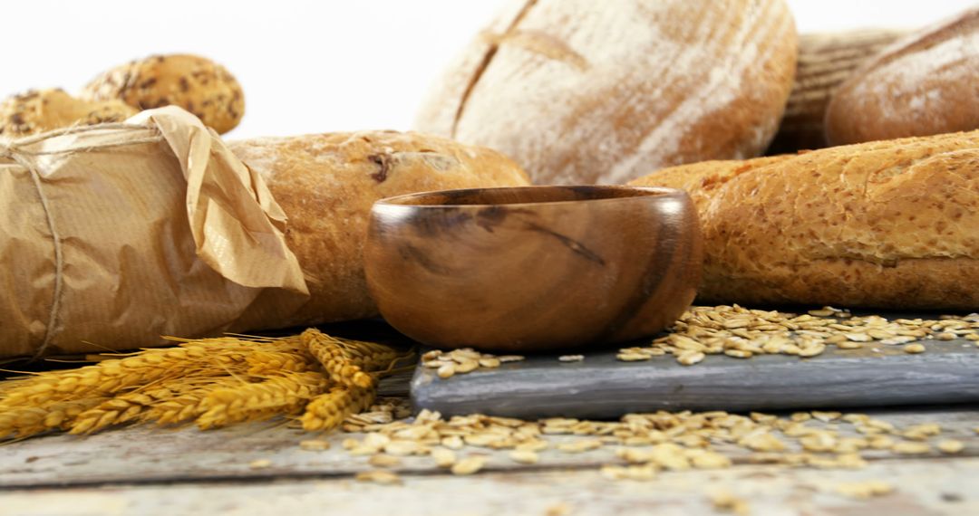 Assorted Bread Selection and Oats with Wooden Bowl on Rustic Table - Free Images, Stock Photos and Pictures on Pikwizard.com