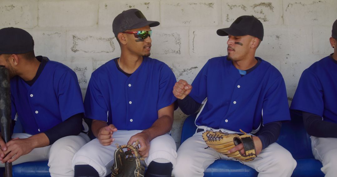 Baseball Players Sitting on Bench and Chatting Before Game - Free Images, Stock Photos and Pictures on Pikwizard.com