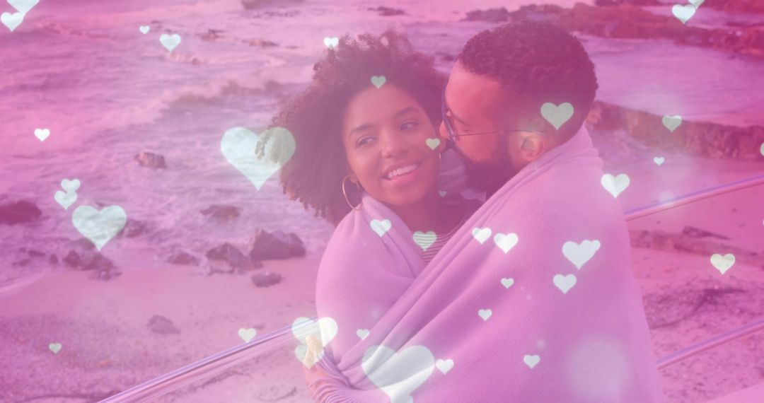 Couple Snuggling with Blanket Near Scenic Ocean