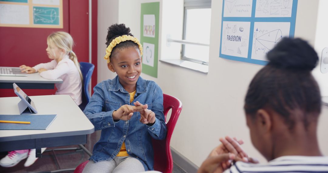 Girls Communicating with Sign Language in Classroom Setting