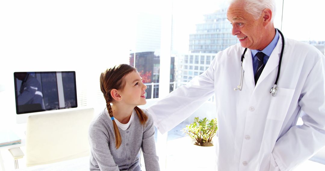 Elderly Doctor Comforting Young Girl in Modern Clinic - Free Images, Stock Photos and Pictures on Pikwizard.com