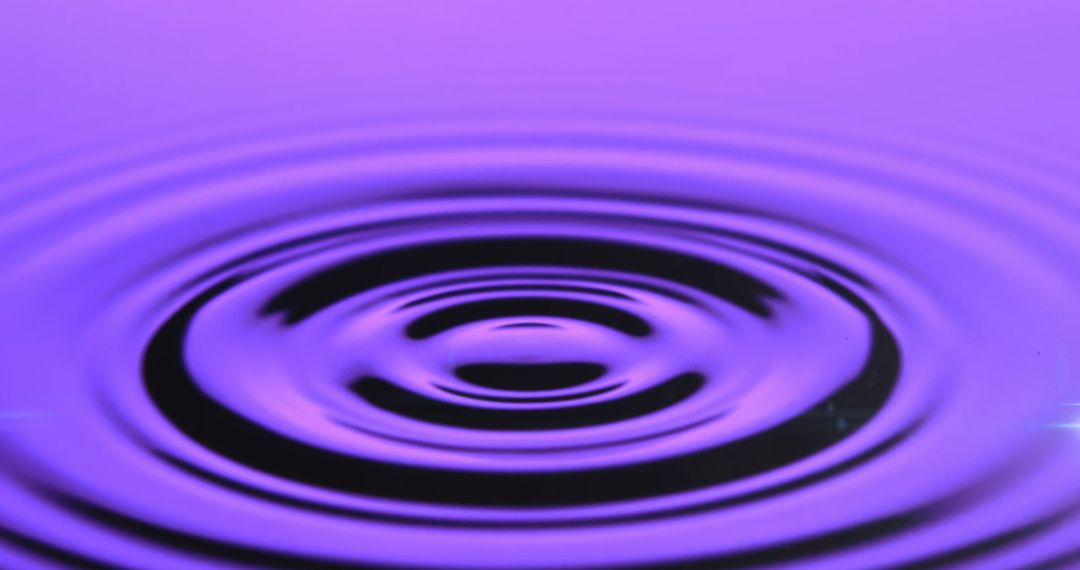 Purple Ripples on Water Surface Creating Tranquil Abstract Patterns