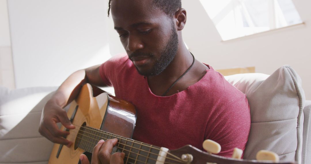 Man Playing Acoustic Guitar at Home for Relaxation