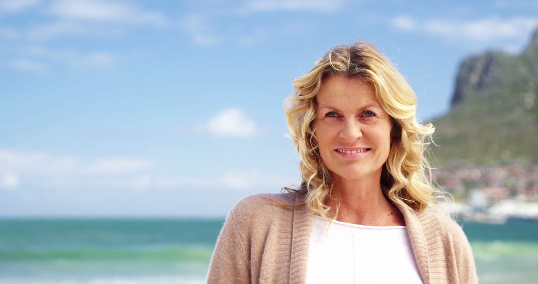 Smiling Middle-aged Woman Enjoying a Day at the Beach - Free Images, Stock Photos and Pictures on Pikwizard.com