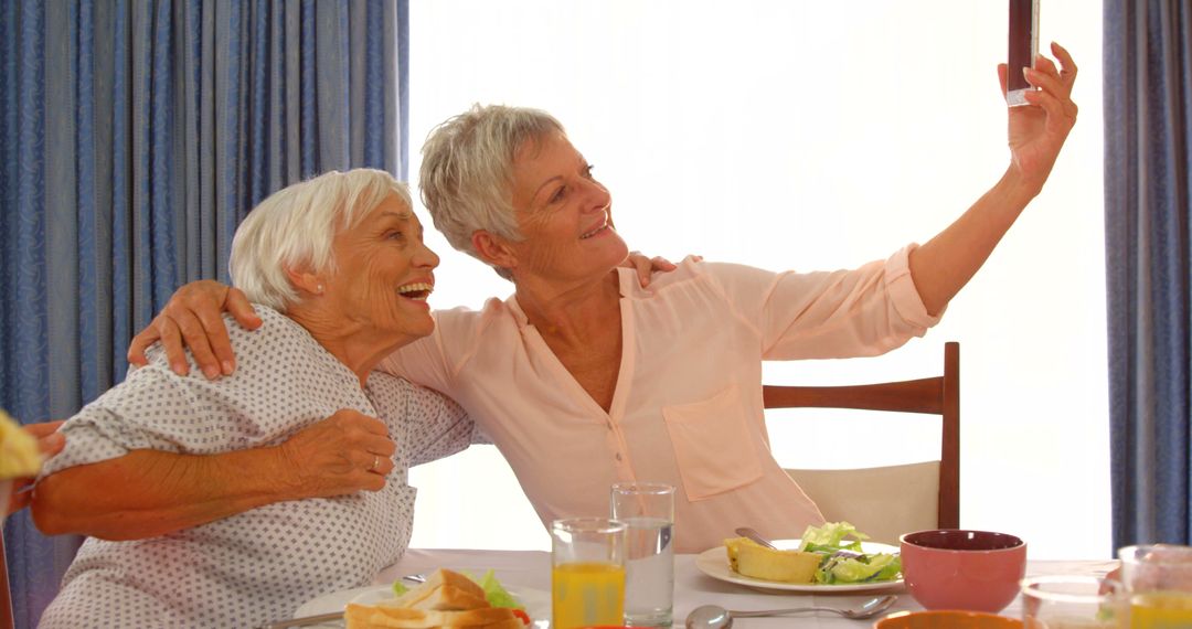 Happy Senior Women Taking Selfie at Breakfast Table - Free Images, Stock Photos and Pictures on Pikwizard.com