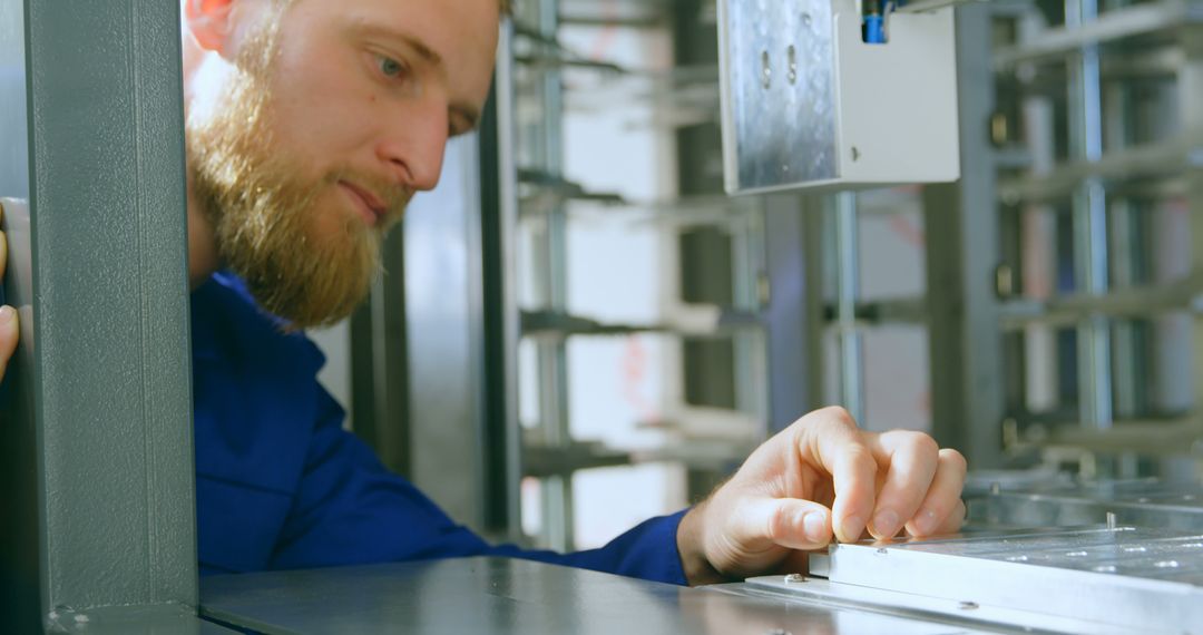 Engineer Adjusting Industrial Equipment in a Factory - Free Images, Stock Photos and Pictures on Pikwizard.com