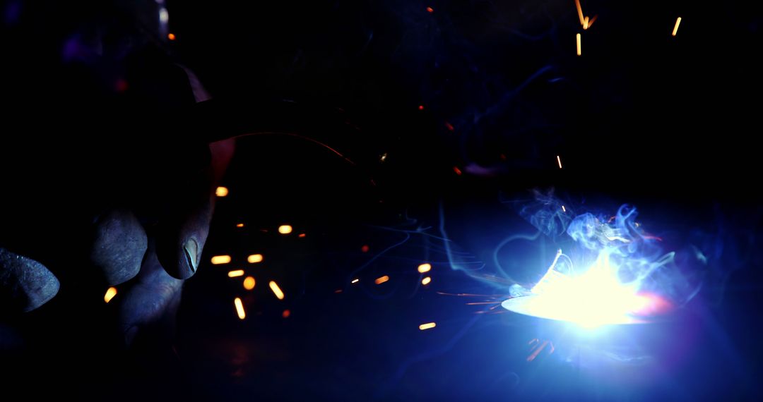 Worker Welding Metal with Bright Sparks - Free Images, Stock Photos and Pictures on Pikwizard.com