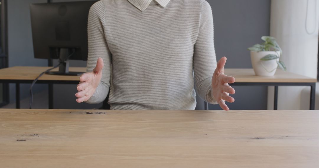 Engaging Businessperson Gesturing at Office Desk