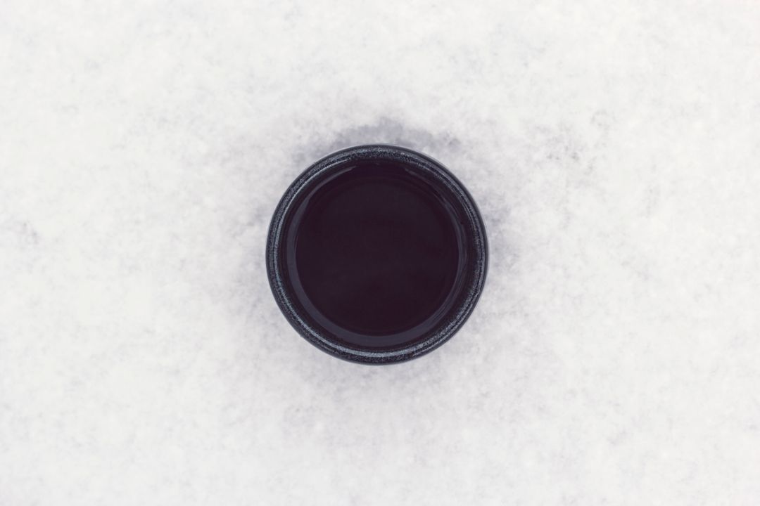 Top View of Black Circle Object on Snow Surface - Free Images, Stock Photos and Pictures on Pikwizard.com