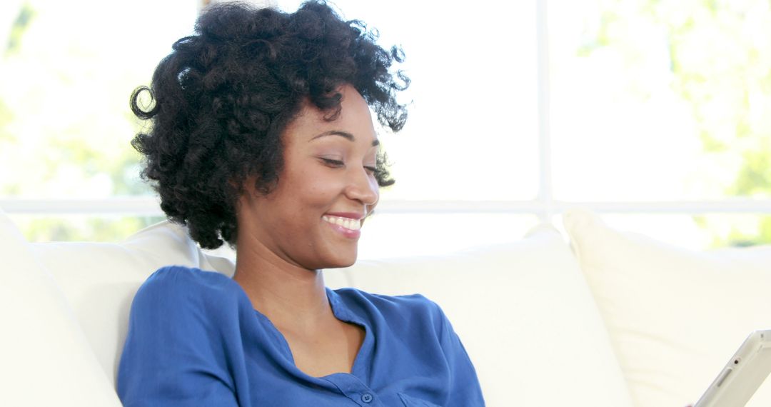 Happy Woman Relaxing on Couch with Tablet - Free Images, Stock Photos and Pictures on Pikwizard.com