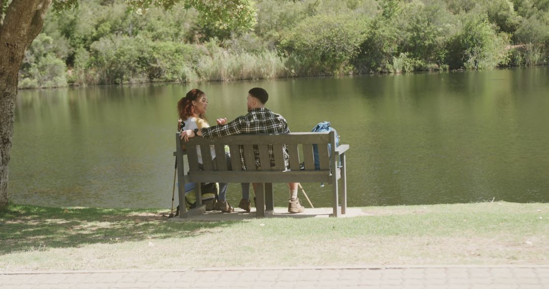 Couple Relaxing on Park Bench by Serene Lake - Free Images, Stock Photos and Pictures on Pikwizard.com