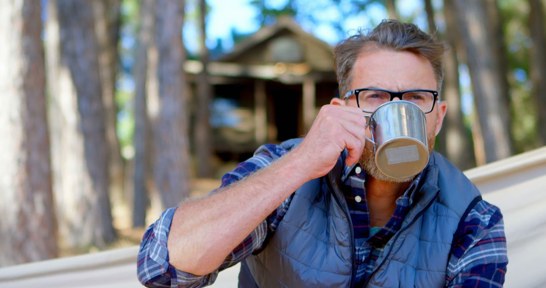 Man Relaxing Outdoors with Hot Beverage in Forest - Free Images, Stock Photos and Pictures on Pikwizard.com