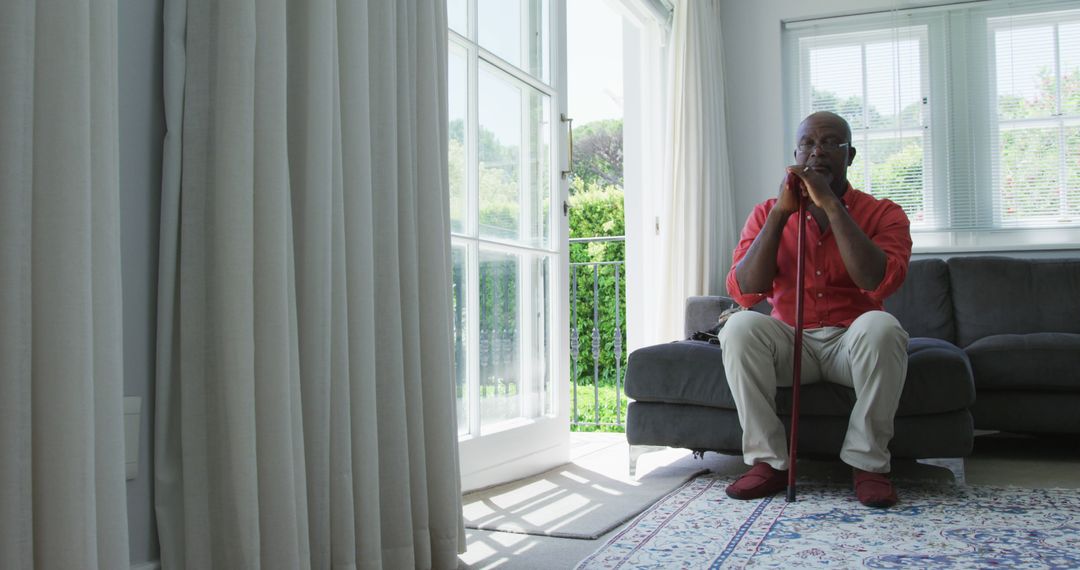 Senior Man Relaxing Indoors with Walking Cane - Free Images, Stock Photos and Pictures on Pikwizard.com