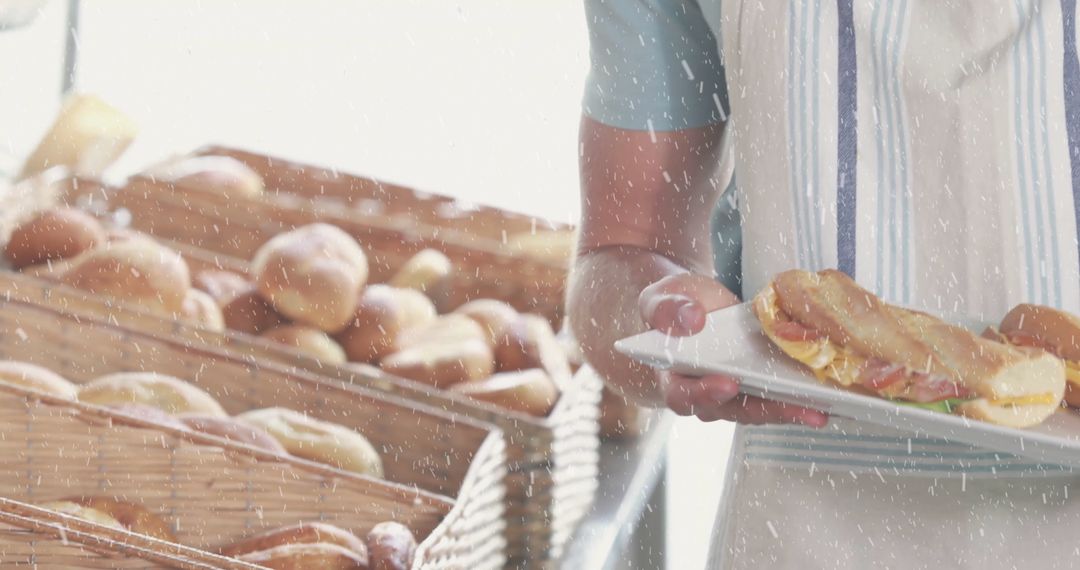 Bakery Attendant Displaying Fresh Artisan Sandwich