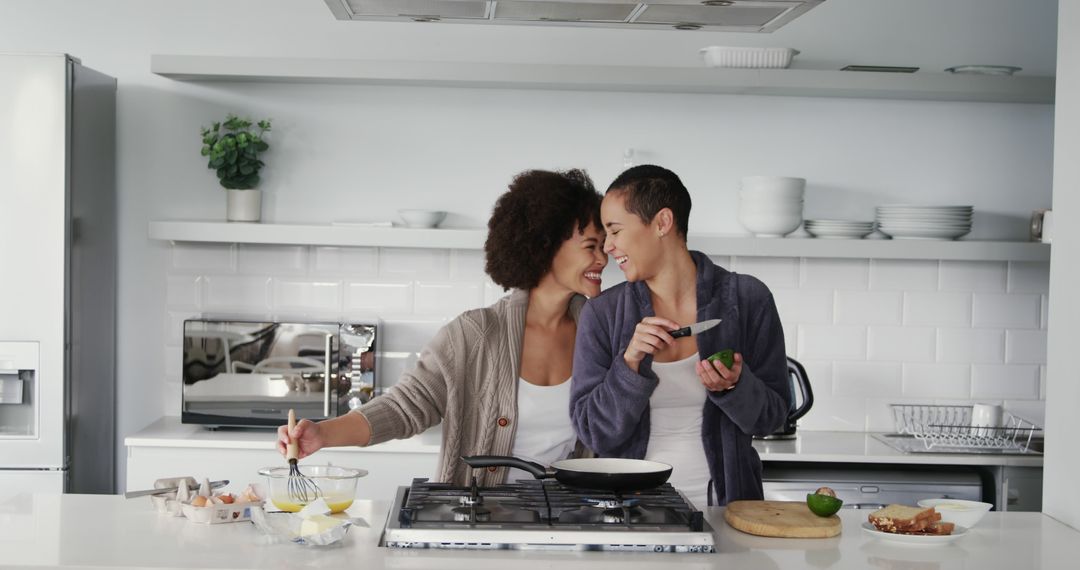 Diverse Lesbian Couple Preparing Breakfast Together in Modern Kitchen - Free Images, Stock Photos and Pictures on Pikwizard.com