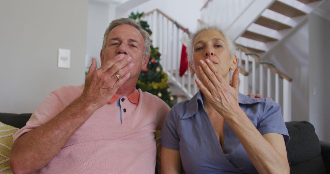 Senior Couple Making Hand Gestures in Living Room - Free Images, Stock Photos and Pictures on Pikwizard.com