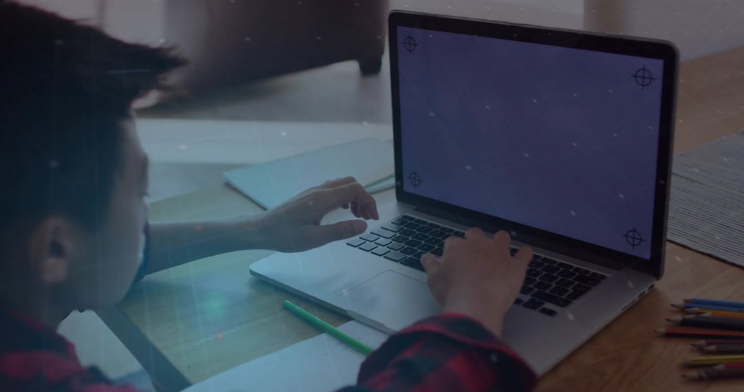 Young Boy Using Laptop Focused on Learning in Home Setting